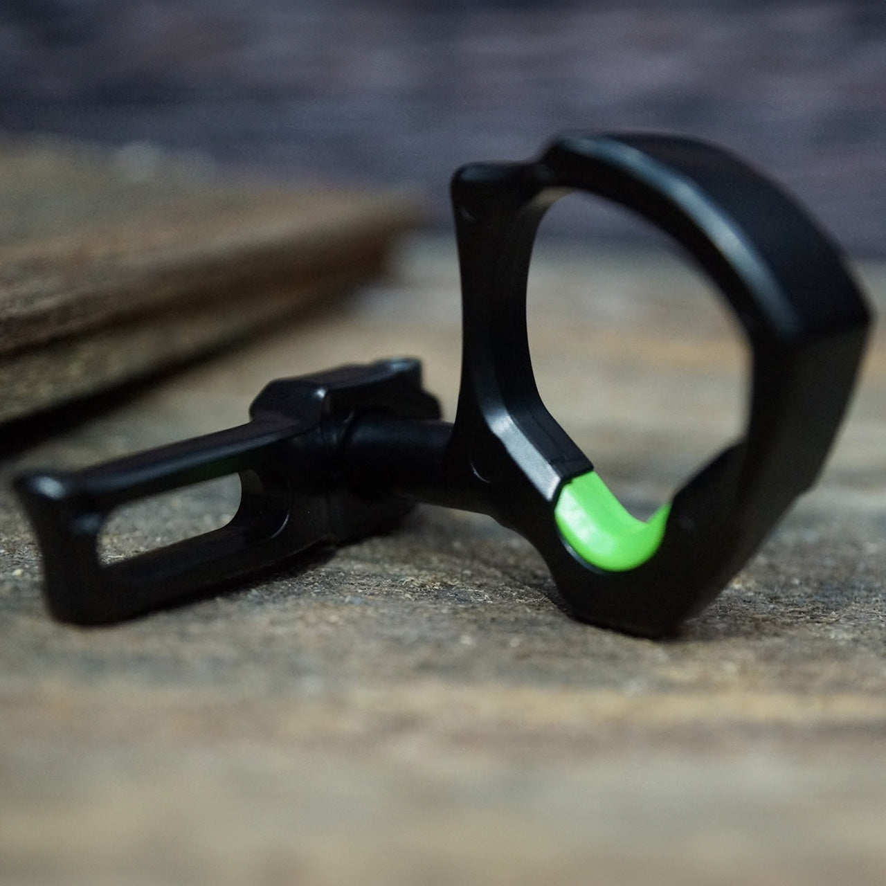 High-performance archery release aid with black and green design for precise shot control.