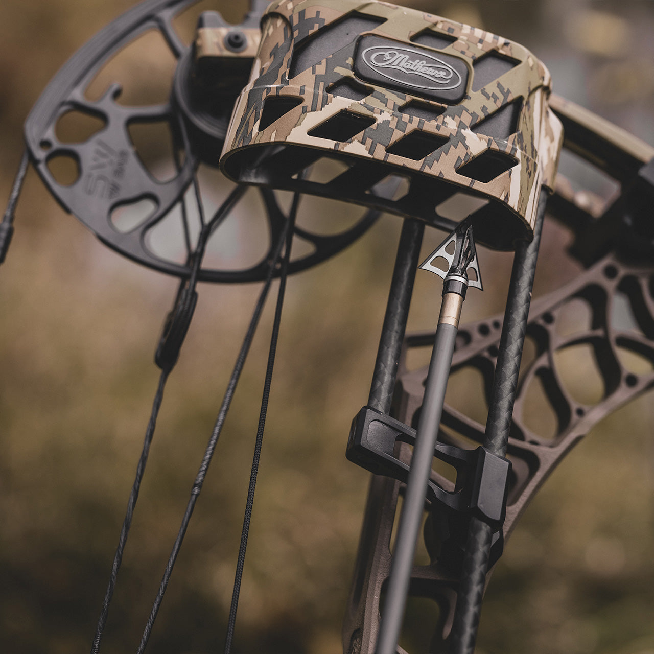 Camouflage compound bow and accessories for outdoor archery hunting.