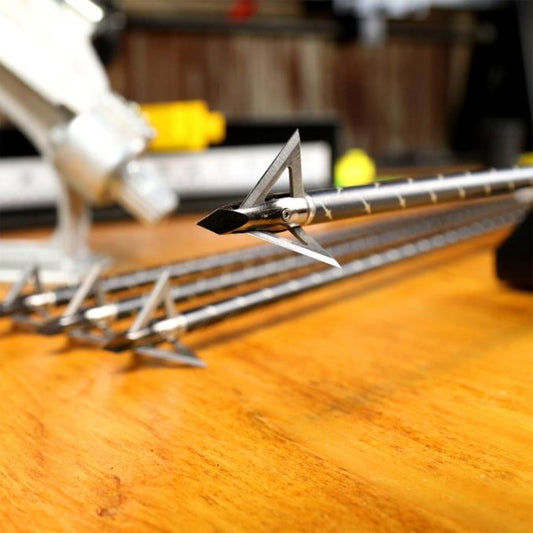 Precision arrow rest on a wooden target table for archery practice and bowhunting.