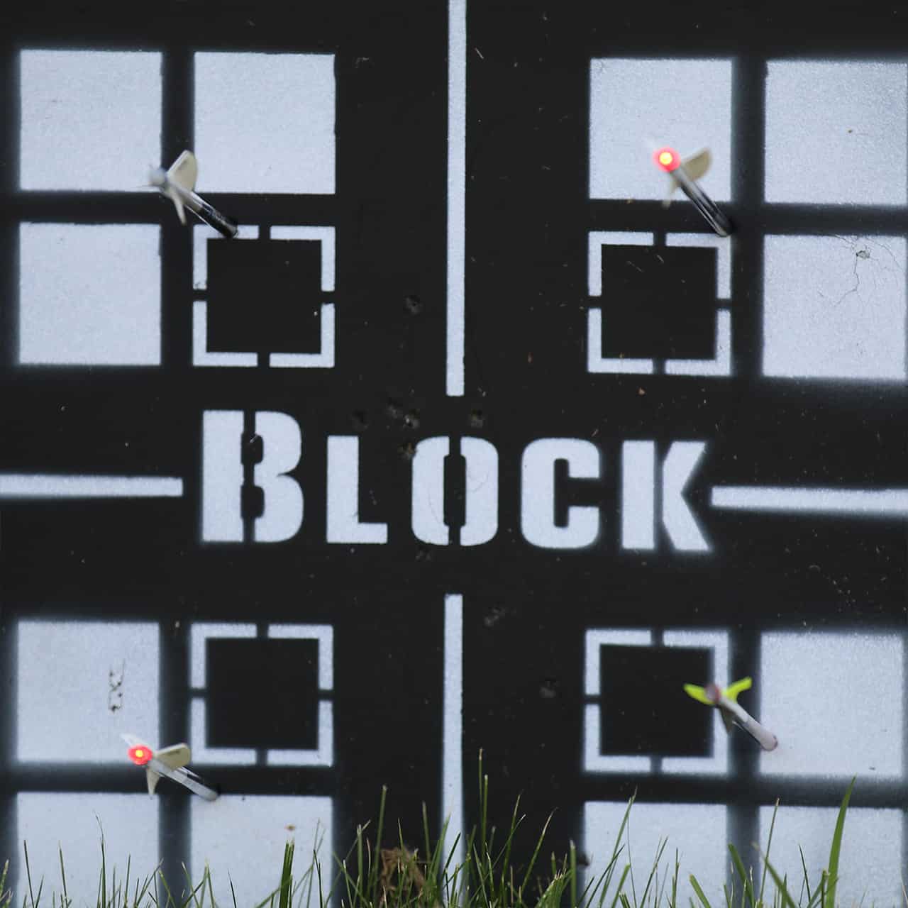 Bright blocking target with the word "BLOCK" and archery arrows hitting designated zones in the center.