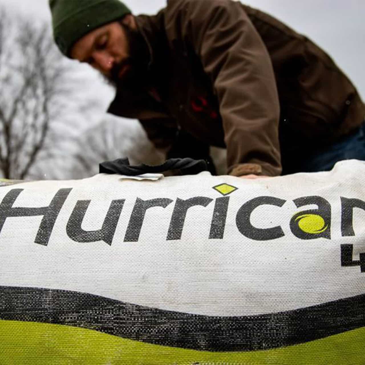 Brightly colored Hurricane bowhunting gear laid out outdoors by a hunter preparing for a hunt.