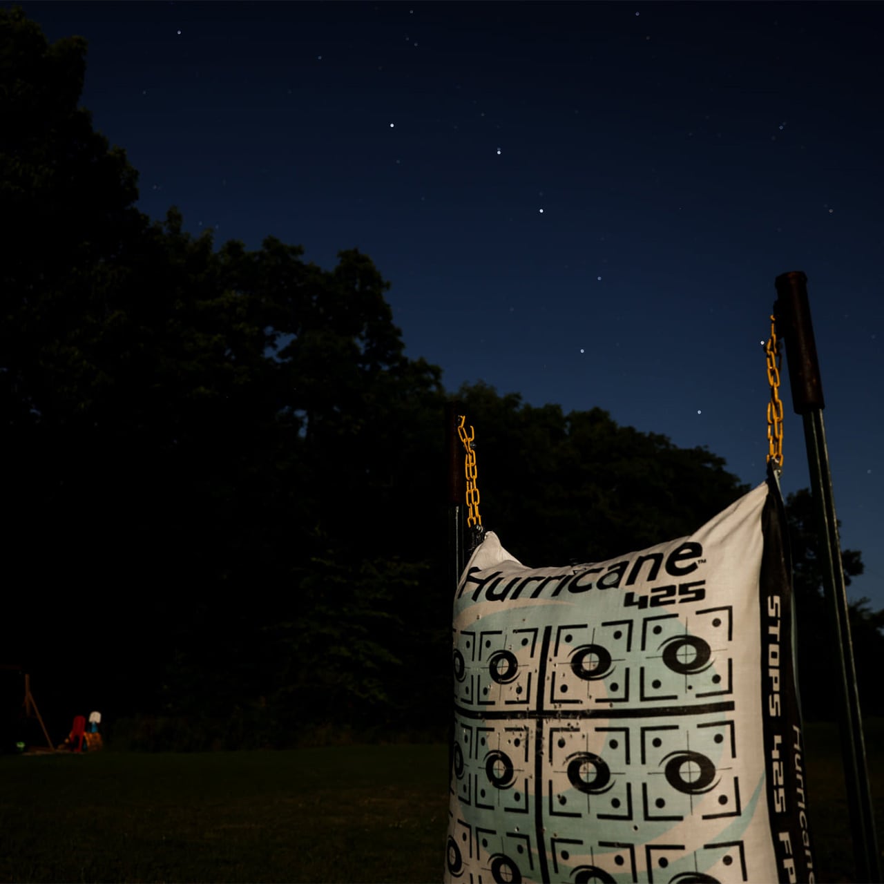 1. Target practice banner hanging outdoors under a starry night sky.