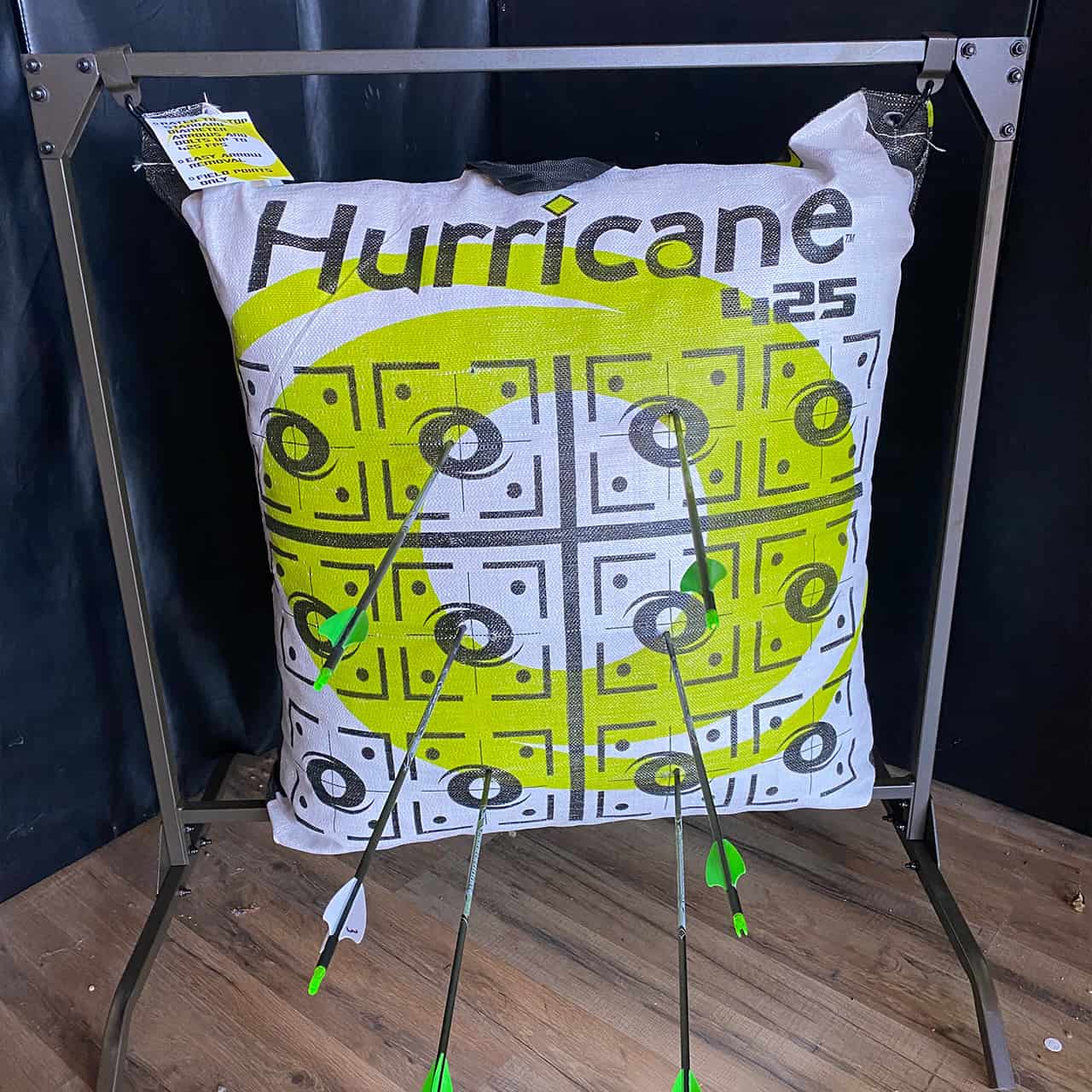 Target archery practice with multiple arrows hitting the bullseye on a Hurricane 4.25 target face.