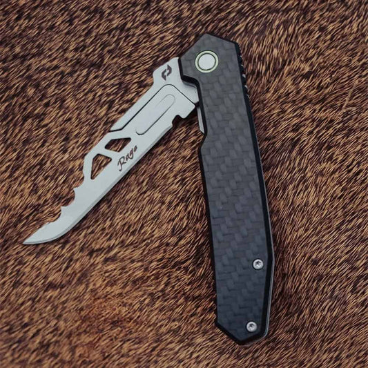Compact folding knife with serrated edge and textured handle for outdoor use.