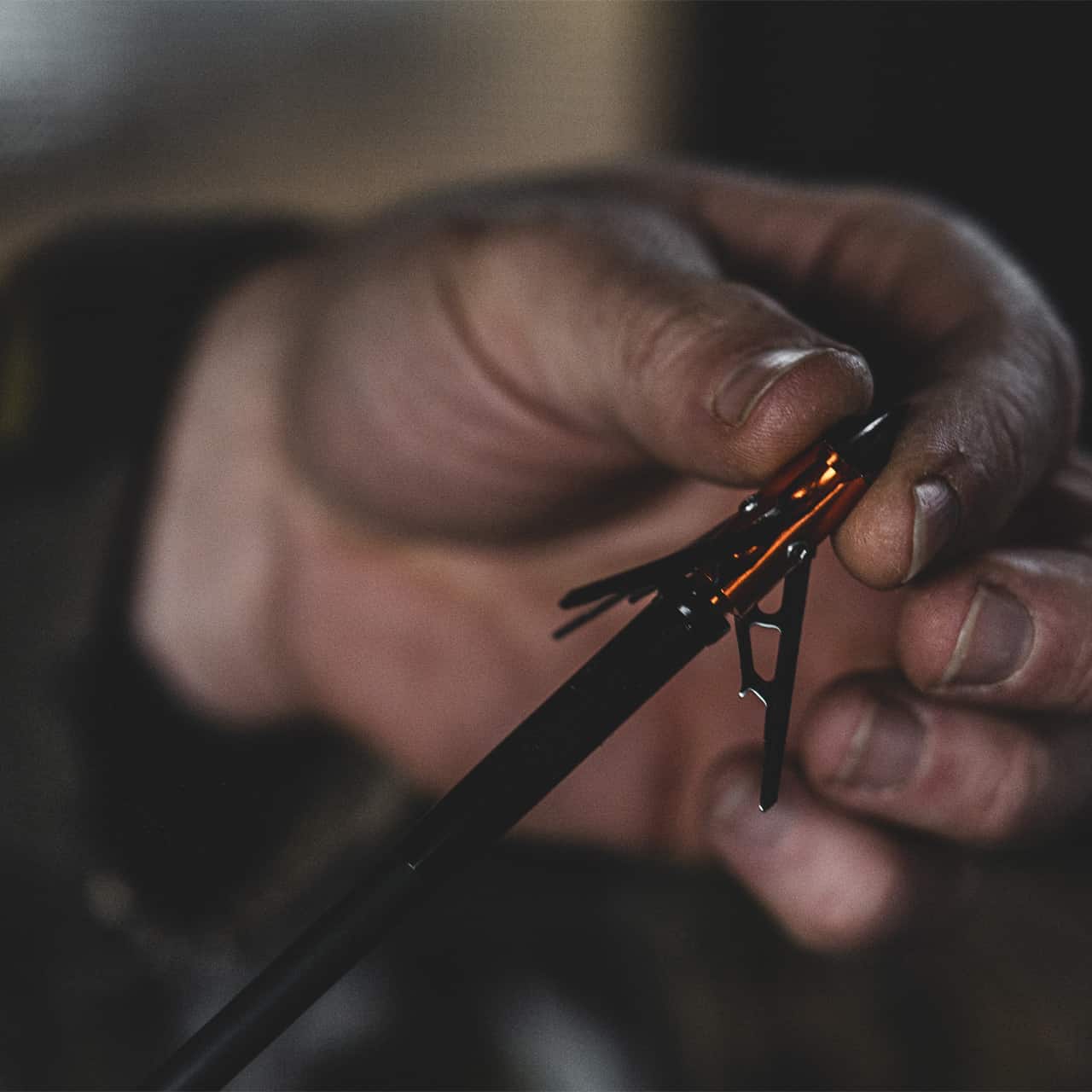 1. Close-up of a person assembling an archery arrow rest, focusing on detailed work.
