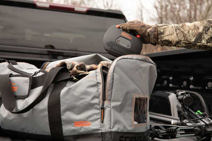 Portable speaker in a hunter's gear bag for outdoor activities and bowhunting.