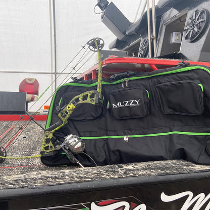 Bright green camouflage bow and black bowhunting gear bag on truck bed for outdoor archery.