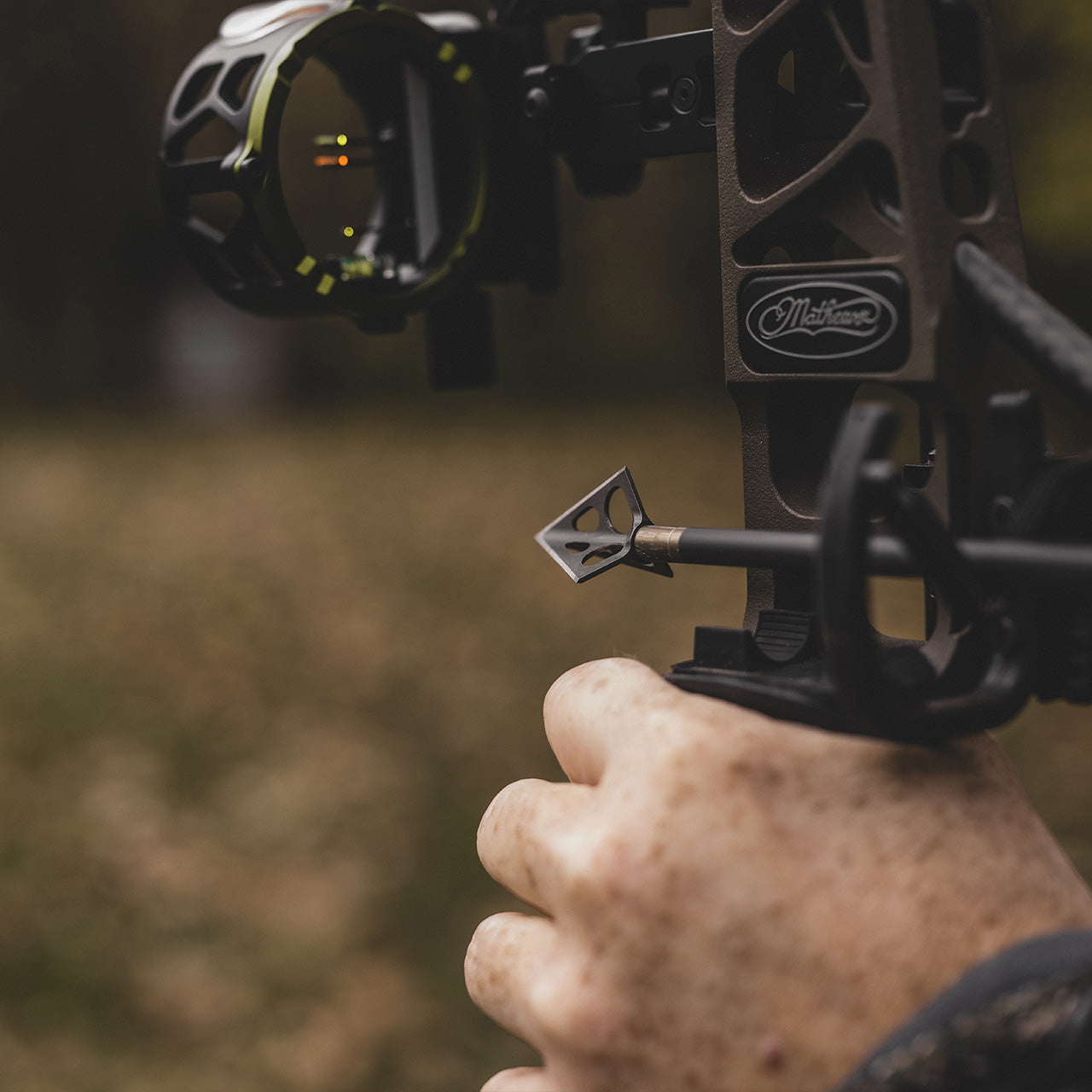 Brightly-lit archery sight mounted on a bow, ready for precision shooting outdoors.