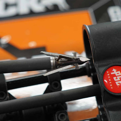 Sharp broadhead arrow tip on black carbon shaft for archery hunting.
