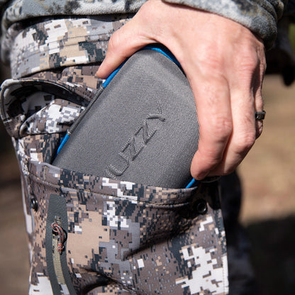 Softshell Bluetooth speaker in the side pocket of camouflage hunting gear.