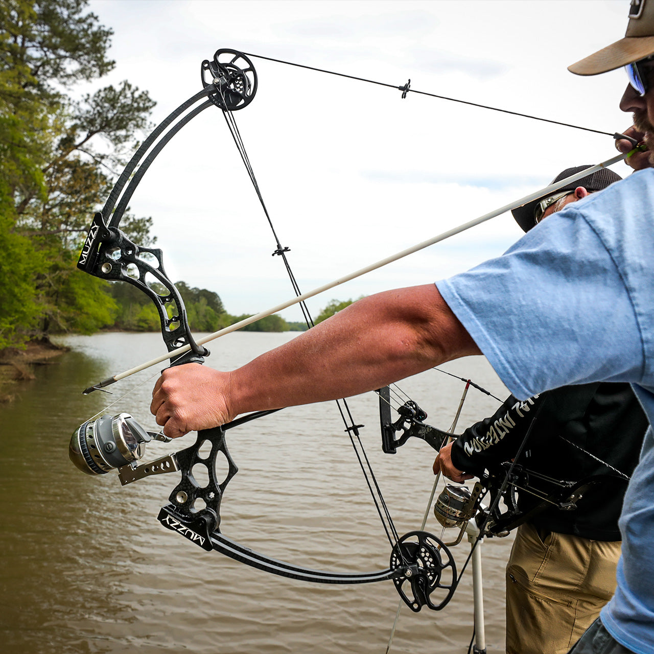 High-performance compound bow with scope used for bowfishing in freshwater river setting.