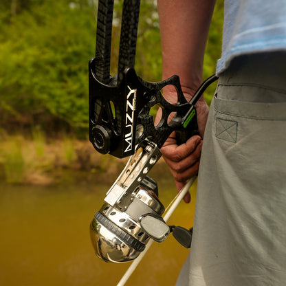 High-performance bow with arrow rest and stabilizer in natural outdoor setting.