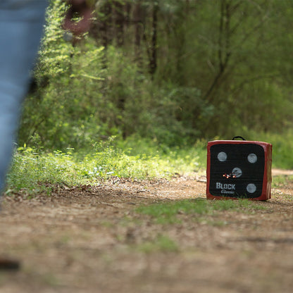 Target practice in a lush forest setting with a portable archery target on the trail.