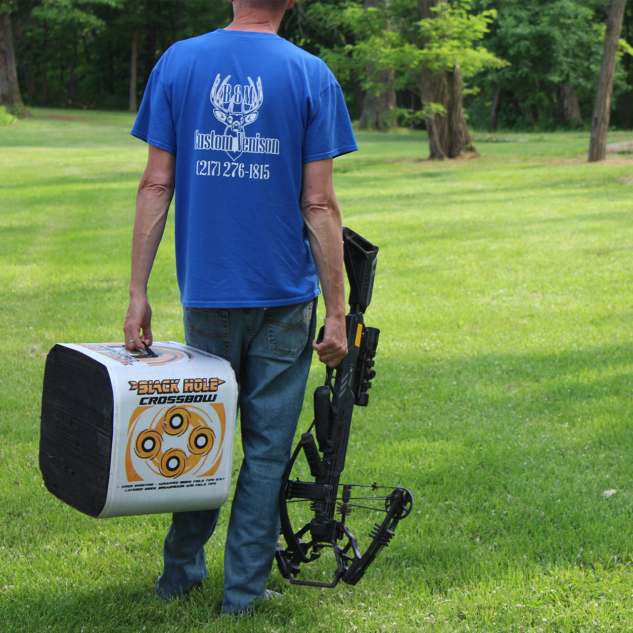 Archery target holder and crossbow at outdoor range for bowhunting practice.