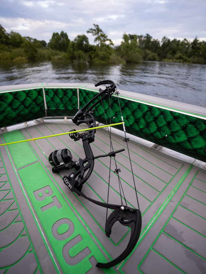 1. Compact fishing bow mounted on a boat with water and trees in the background.