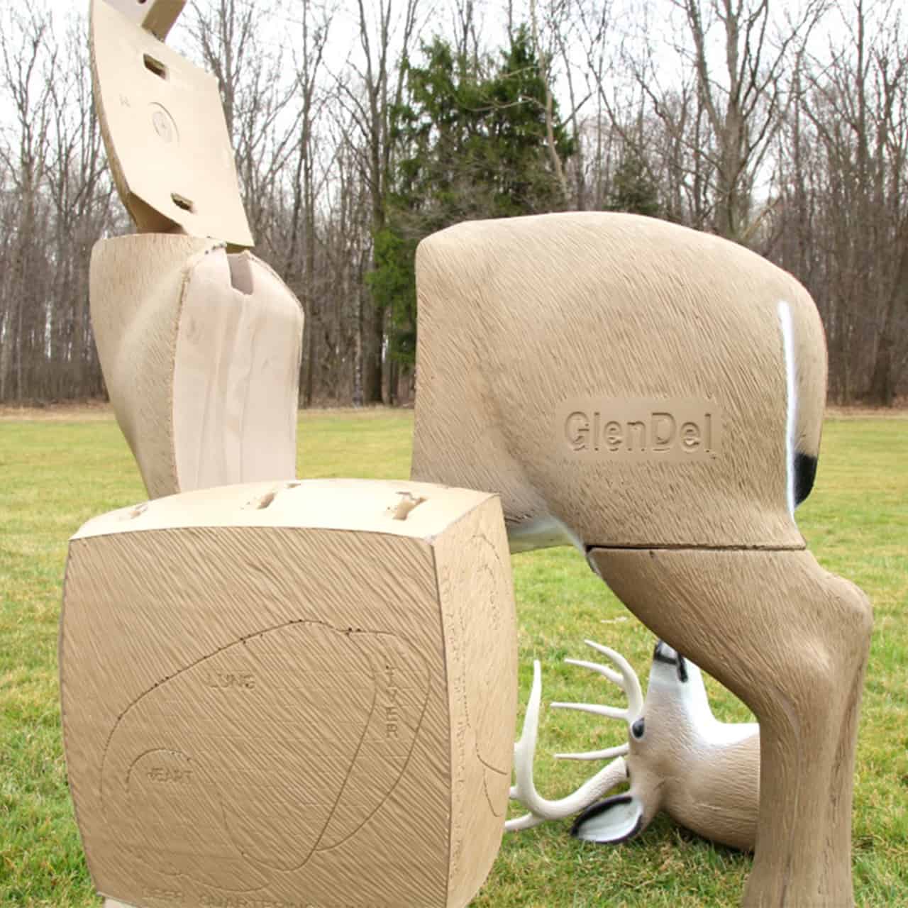 Carved wooden animal targets and blocks outdoors for archery practice at FeraDyne Outdoors.
