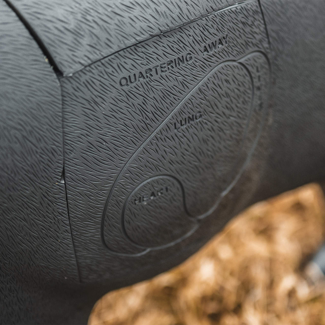 Rubber bowhunting target with textured surface and engraved guidelines for archery practice.