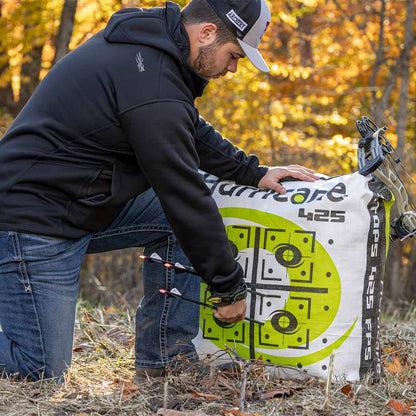 Archery target being set up outdoors during fall foliage.