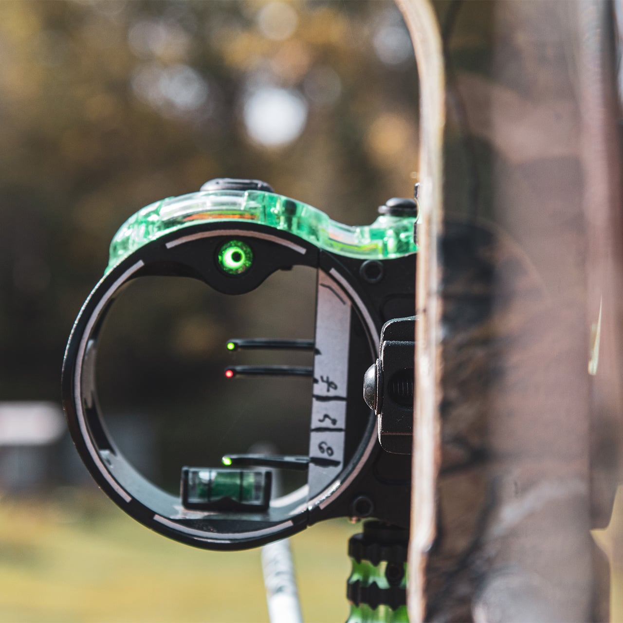 High-tech archery sight with illuminated scope for bowhunting and precision shooting.