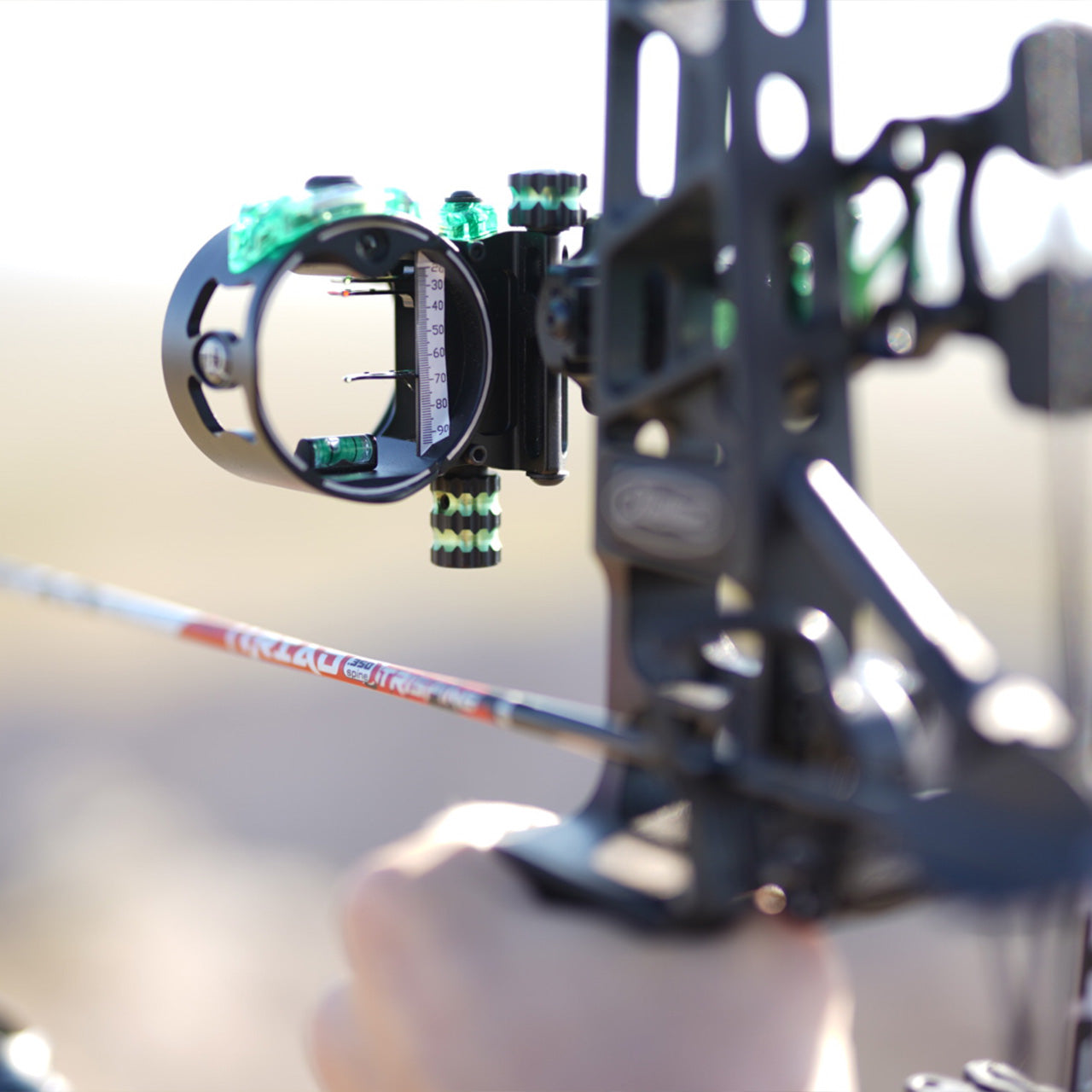 FiberOptic bow sight with pin and level on a modern compound bow for bowhunting and archery.