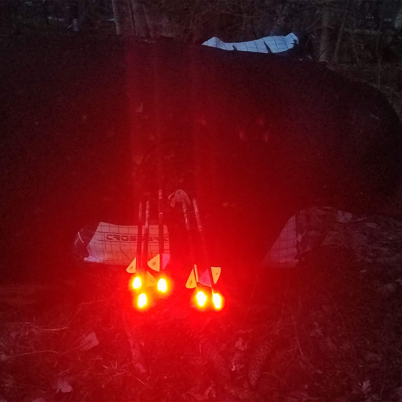 Reflective safety lights attached to a backpack for outdoor visibility at night.