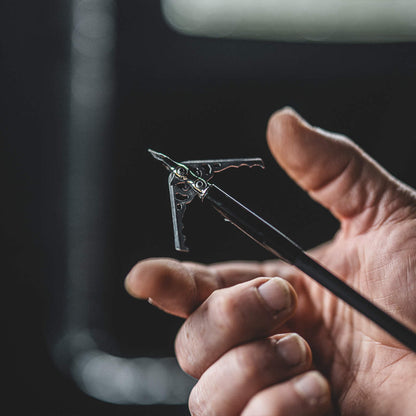 Precision bowstring nock installation, essential for accurate arrow release and bow performance.