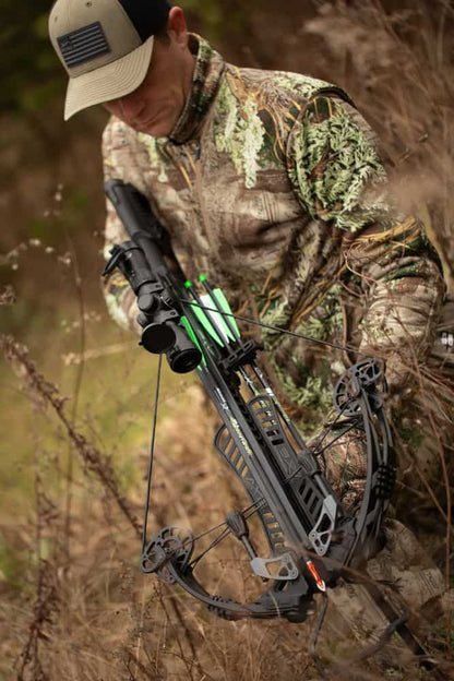 High-tech crossbow with illuminated scope in natural outdoor setting for hunting.