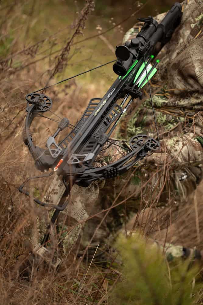 High-performance compound bow with modern design, camouflage finish, and advanced sighting system for hunting.