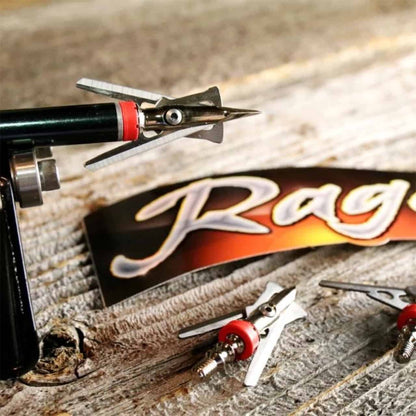 Precision crossbow broadhead arrow on a textured wooden surface with a Rage logo banner.