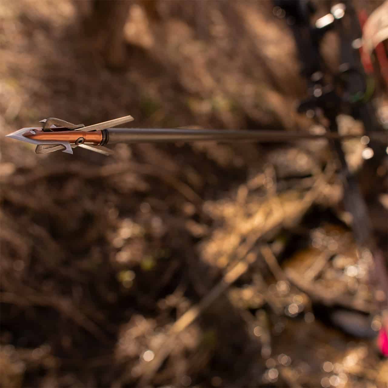 High-tech carbon arrow with broadhead tip for bowhunting and archery competitions.