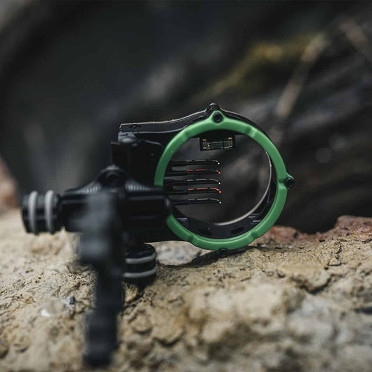 Precision bow sight on rocky surface for archery accuracy and outdoor hunting.