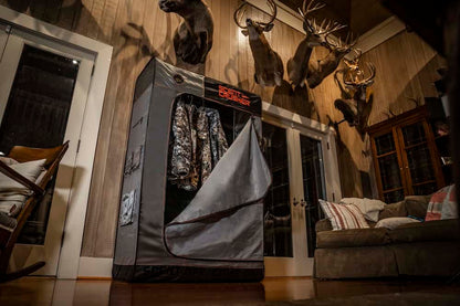 High-tech drying cabinet inside a hunting cabin, storing camouflage gear.