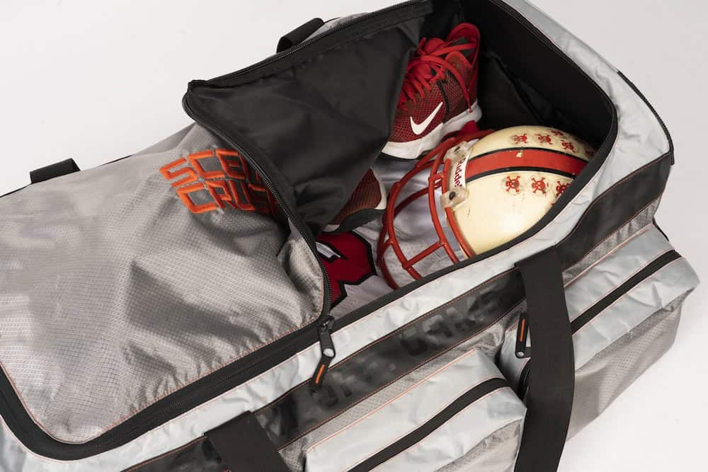 Sporting goods gear packed in gray and black duffle bag for outdoor archery and bowhunting trips.