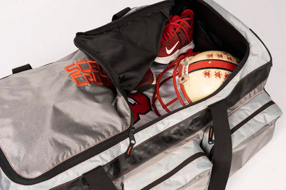 Sporting goods gear packed in gray and black duffle bag for outdoor archery and bowhunting trips.