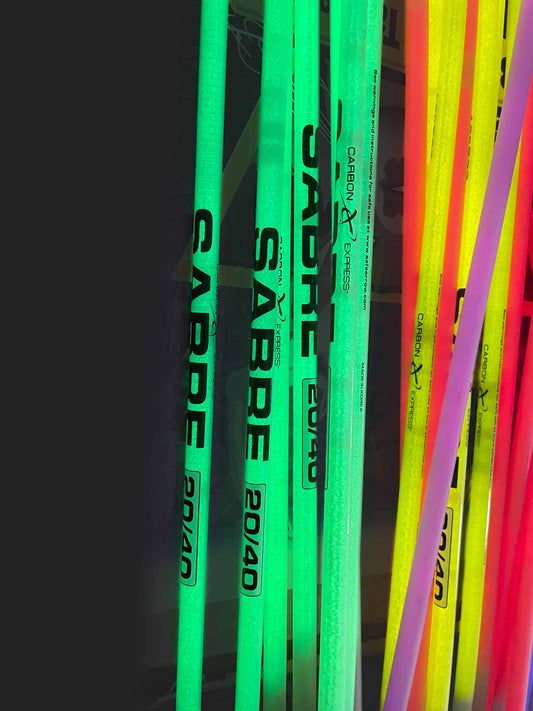 Glow in the dark archery arrows with neon colors for night hunting or target practice.