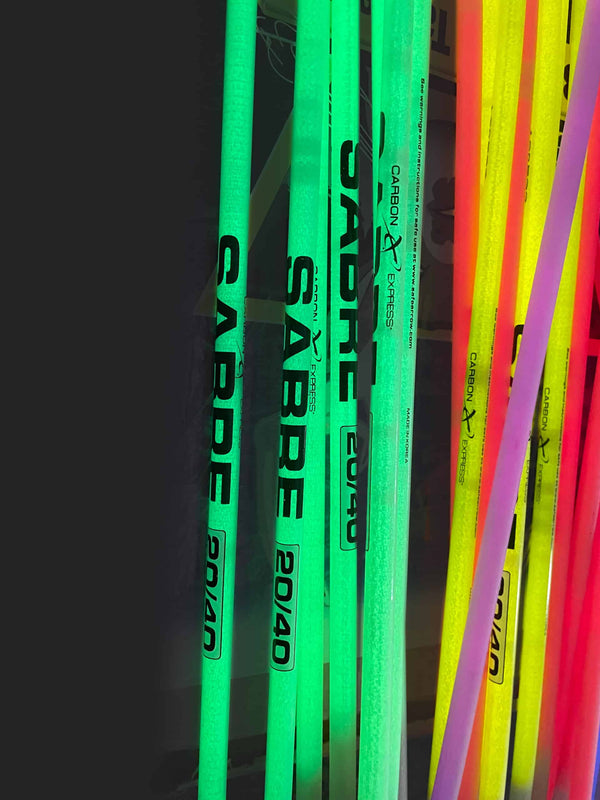 Glow in the dark archery arrows with neon colors for night hunting or target practice.