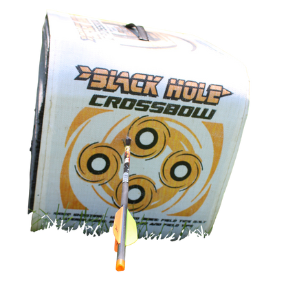 Target for archery with a bow and arrow on a green grassy field.