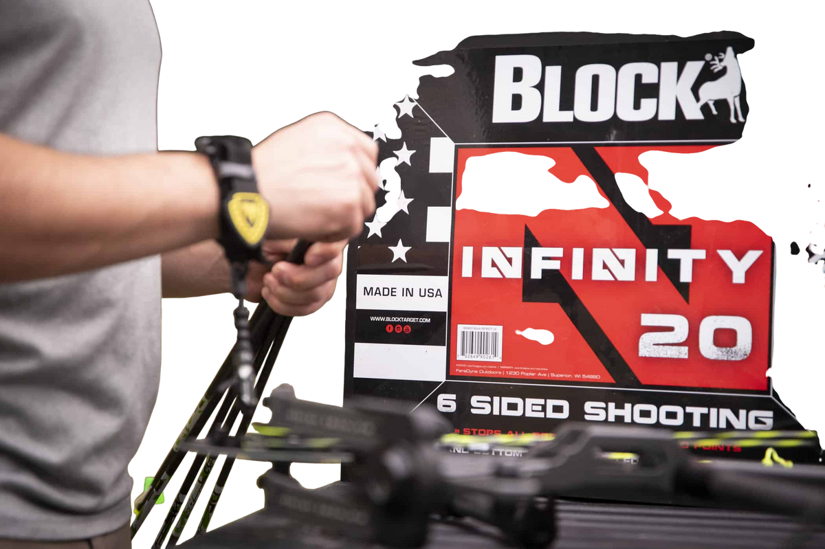 1. person adjusting a bow sight at an archery shooting range outdoors.