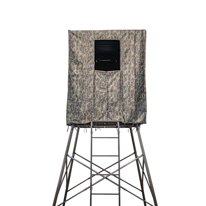Camouflage hunting blind on elevated stand for bowhunting in the outdoors.