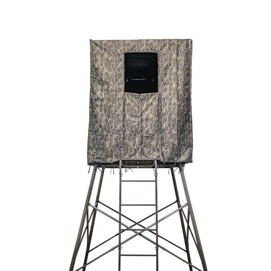 Camouflage hunting blind on elevated stand for bowhunting in the outdoors.