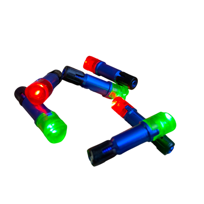 Red, blue, green, and black LED lights in a wooden crack with chopped wood surrounding it.