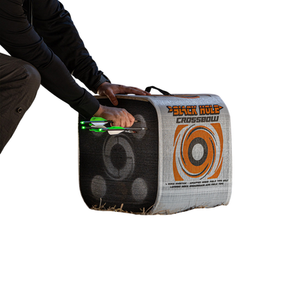 1. Archery target with illuminated arrows set inside a barn for indoor practice.