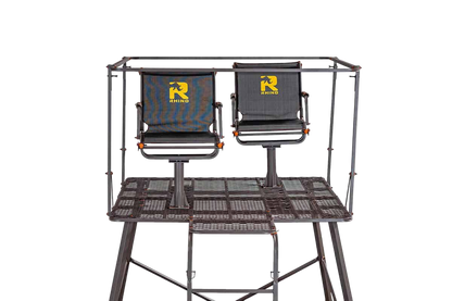 Dual hunting chairs mounted on a sturdy platform with a protective frame, ideal for outdoor archery and bowhunting.