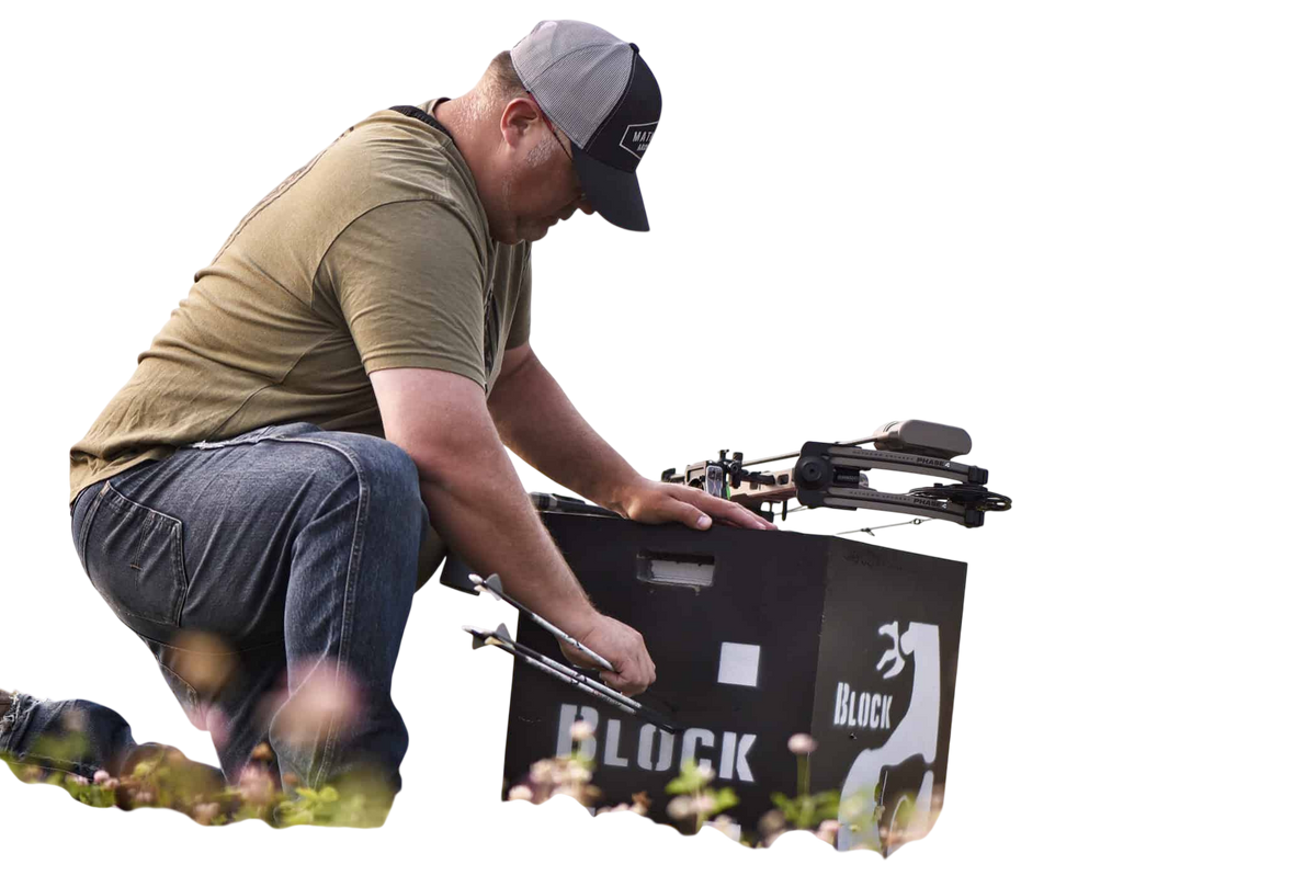 1. Man preparing a bow on outdoor field with target gear, landscape background, archery gear, bowhunting, FeraDyne.