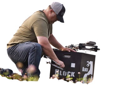 1. Man preparing a bow on outdoor field with target gear, landscape background, archery gear, bowhunting, FeraDyne.