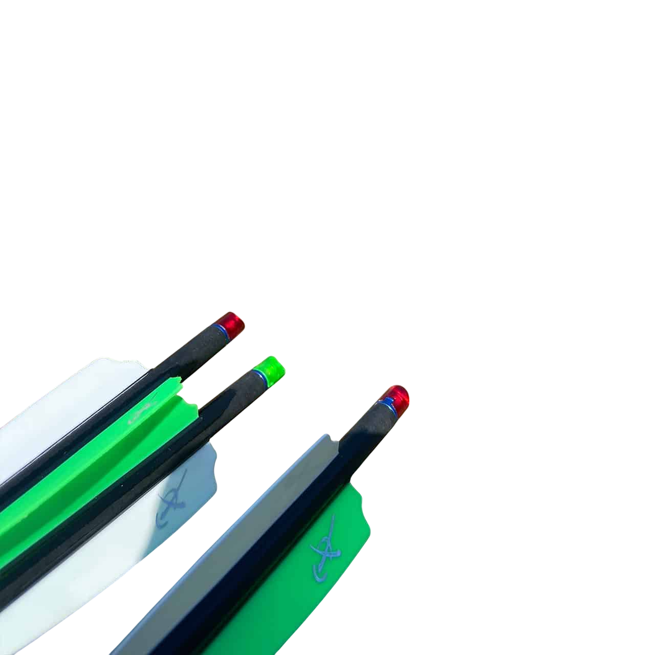 Bright green and white fletched arrows with red and blue nocks on a bow rest outdoors.