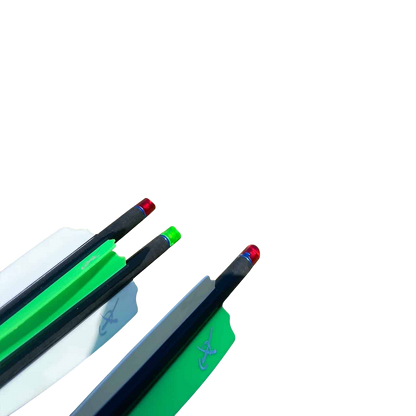 Bright green and white fletched arrows with red and blue nocks on a bow rest outdoors.