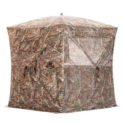 Camo hunting blind with mesh windows and zippered entrance for bowhunting in outdoor terrain.