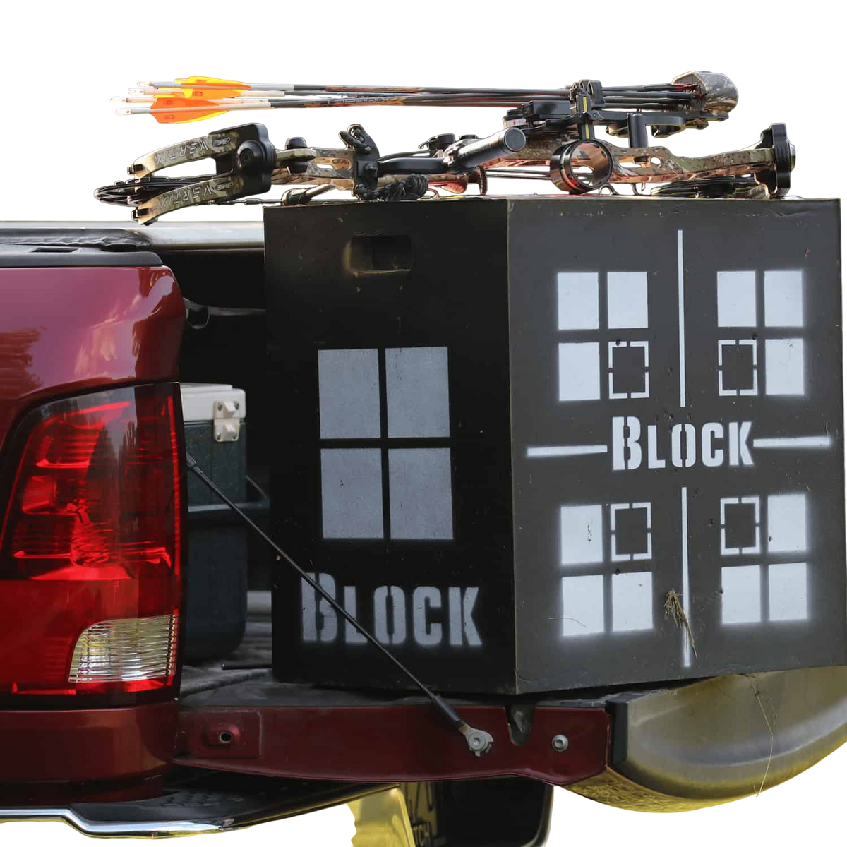 Crossbow and archery gear loaded in truck bed with a Block target for archery practice.