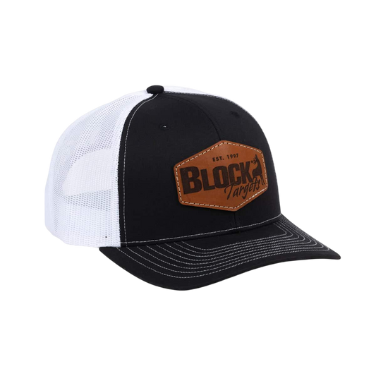 Vintage trucker cap with leather patch and mesh back, ideal for outdoor activities.